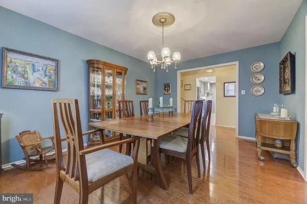 a view of a dining room with furniture and a chandelier
