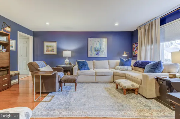a living room with furniture a large window and table