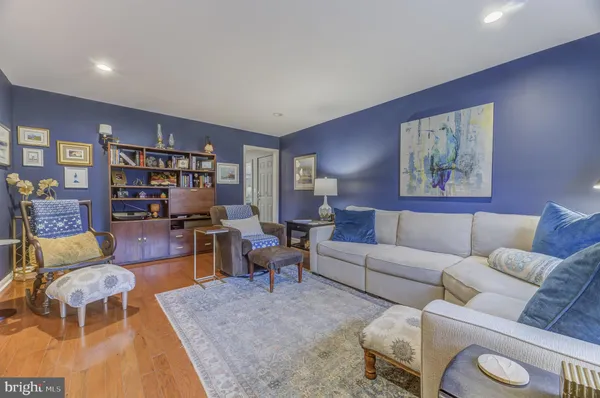 a living room with furniture and painting on the wall