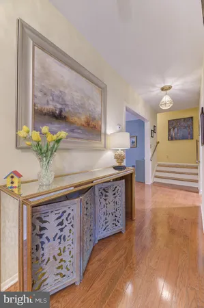 a view of a kitchen with furniture and wooden floor