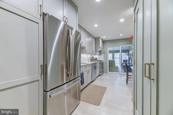 a kitchen with stainless steel appliances a refrigerator and a refrigerator
