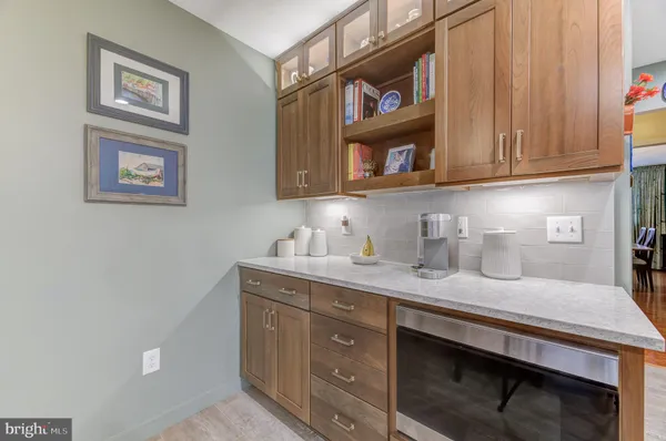 a kitchen with a sink cabinets and a wooden floor