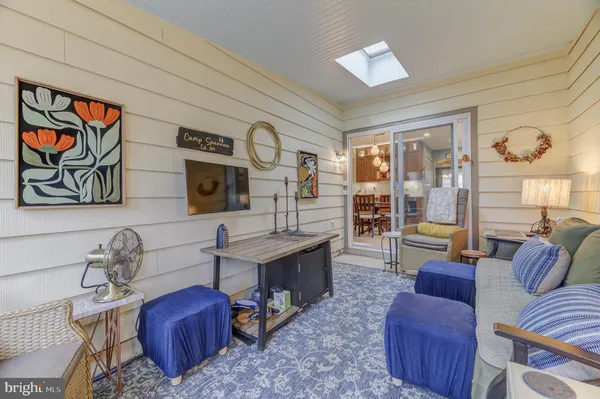 a living room with furniture a rug and a painting on the wall