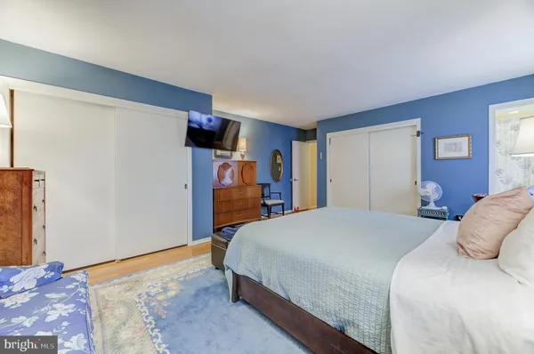 a bedroom with a bed and a walk in closet