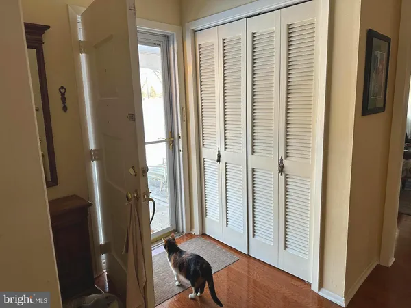 a view of a hallway with a large mirror and a window