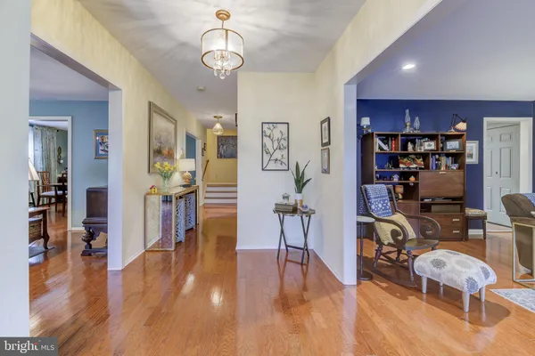 a view of a dining room with furniture wooden floor and chandelier