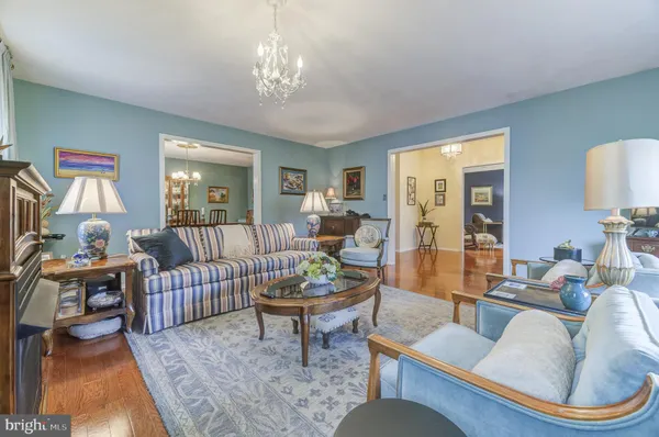 a living room with furniture and a chandelier