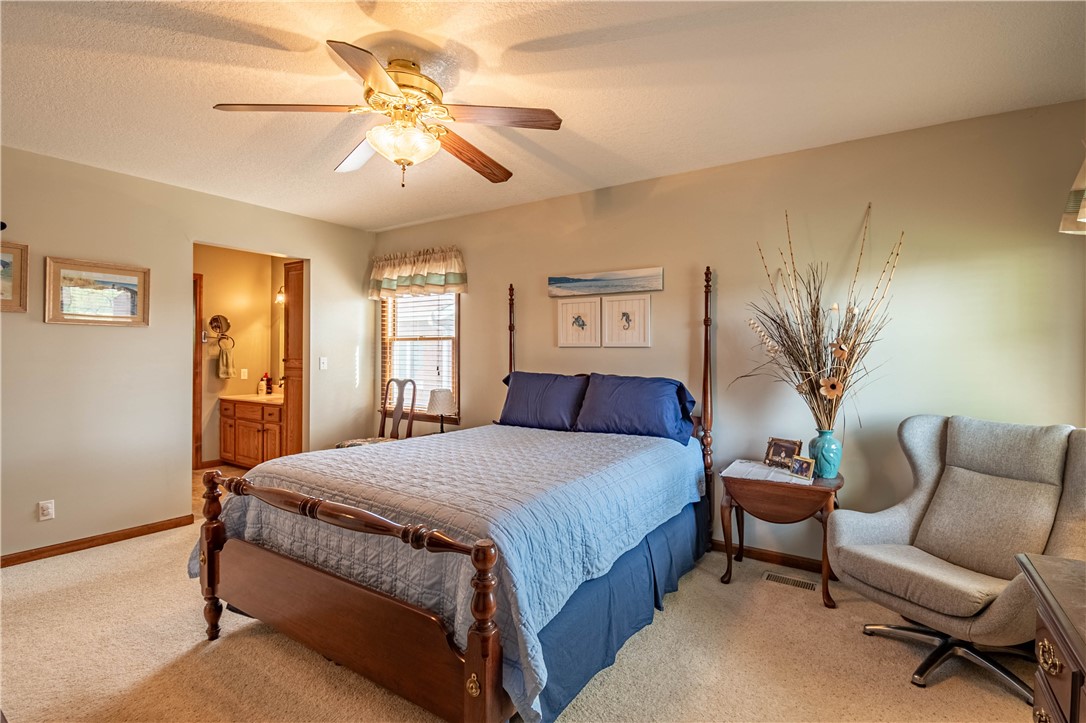 1011 Bunker Lane Decatur, IL 62526 - Photo 12 of 25 a bedroom with a large bed and a chandelier