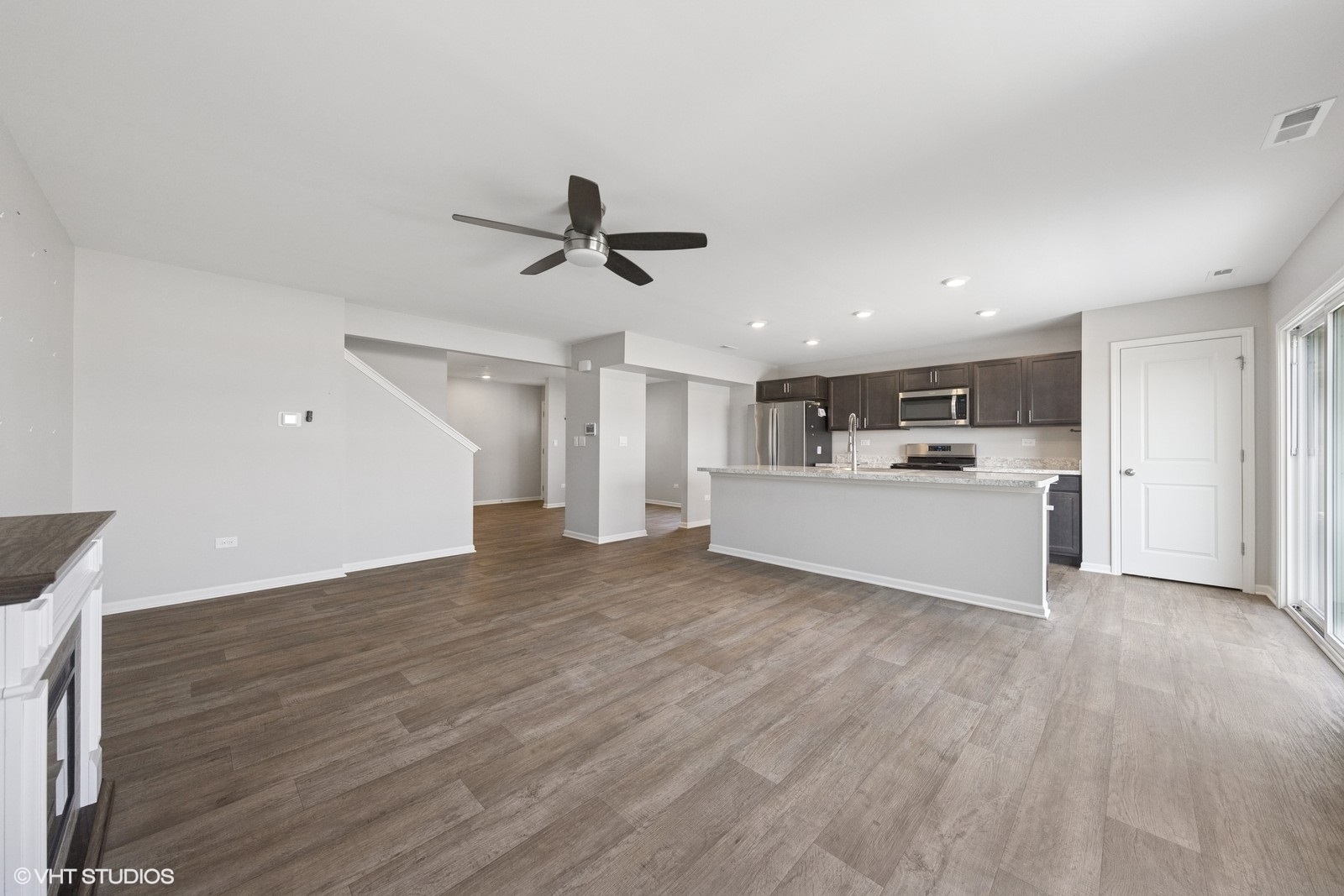 1234 Violet Ct. Joliet, IL 60431 - Photo 6 of 23 a view of a livingroom with a kitchen counter top space and wooden floor