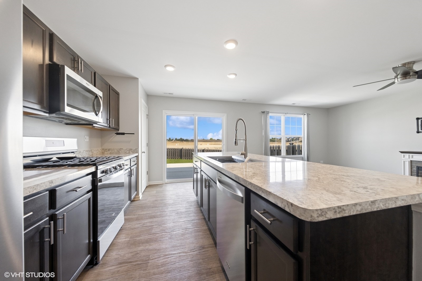 1234 Violet Ct. Joliet, IL 60431 - Photo 7 of 23 a kitchen with stainless steel appliances granite countertop a kitchen island a stove and a sink