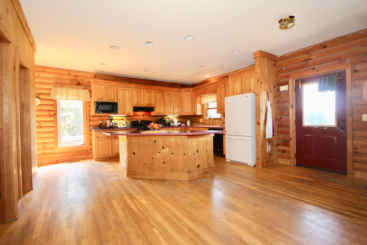 4860 Indian Valley Road Riner, VA 24149 - Photo 62 of 96 a large kitchen with stainless steel appliances wooden floors and large window