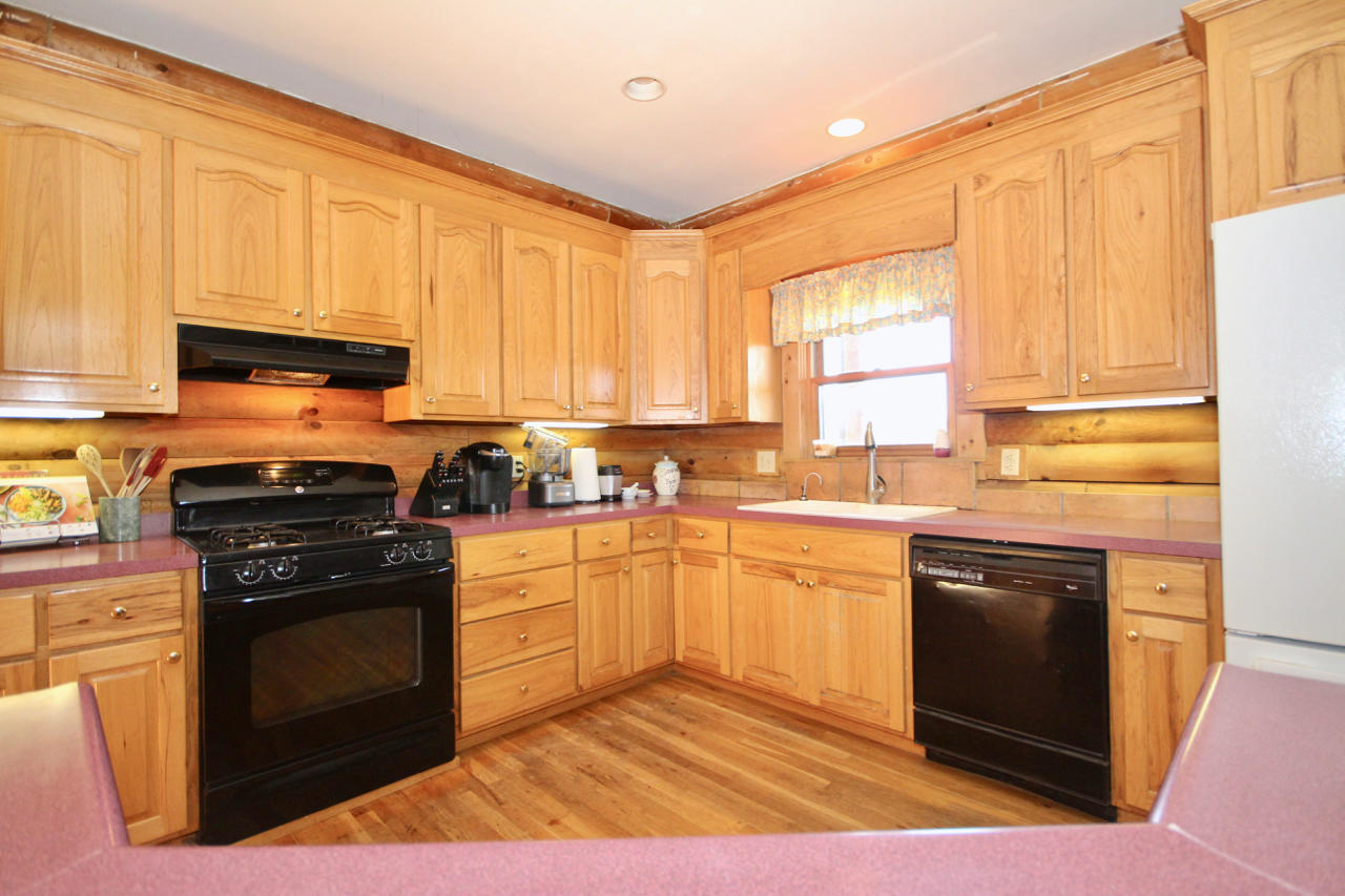 4860 Indian Valley Road Riner, VA 24149 - Photo 64 of 96 a kitchen with a stove a sink and a microwave