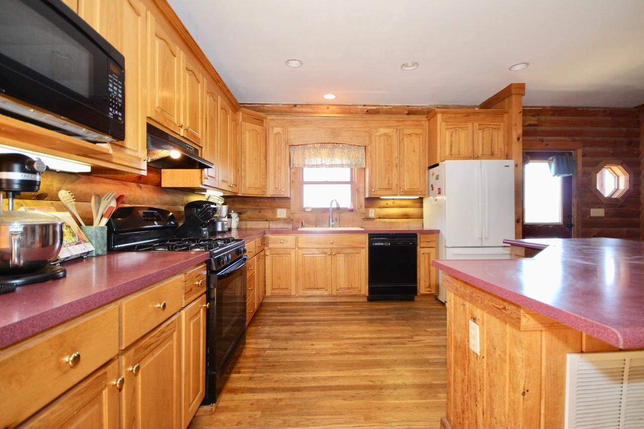 4860 Indian Valley Road Riner, VA 24149 - Photo 66 of 96 a kitchen with stainless steel appliances granite countertop a stove a sink and a microwave