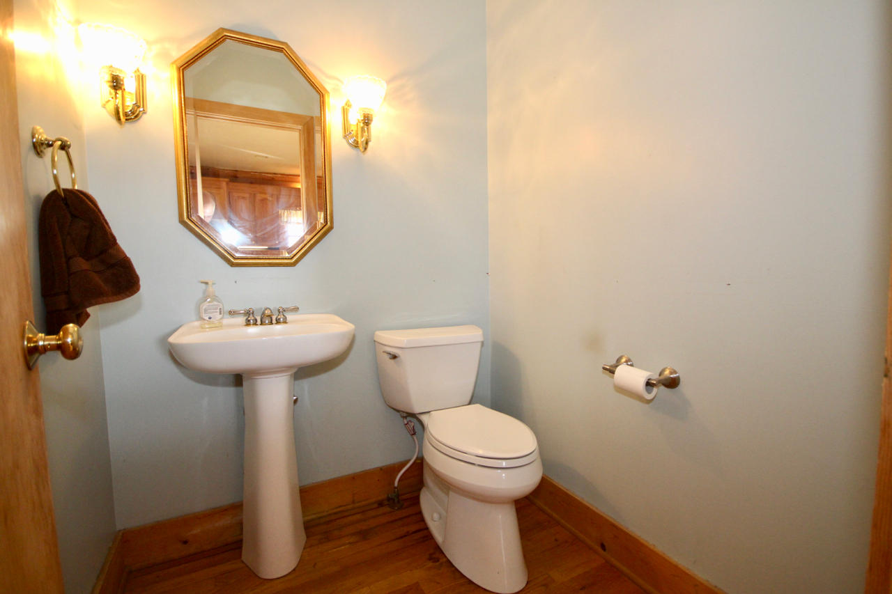 4860 Indian Valley Road Riner, VA 24149 - Photo 75 of 96 a bathroom with a toilet sink and mirror