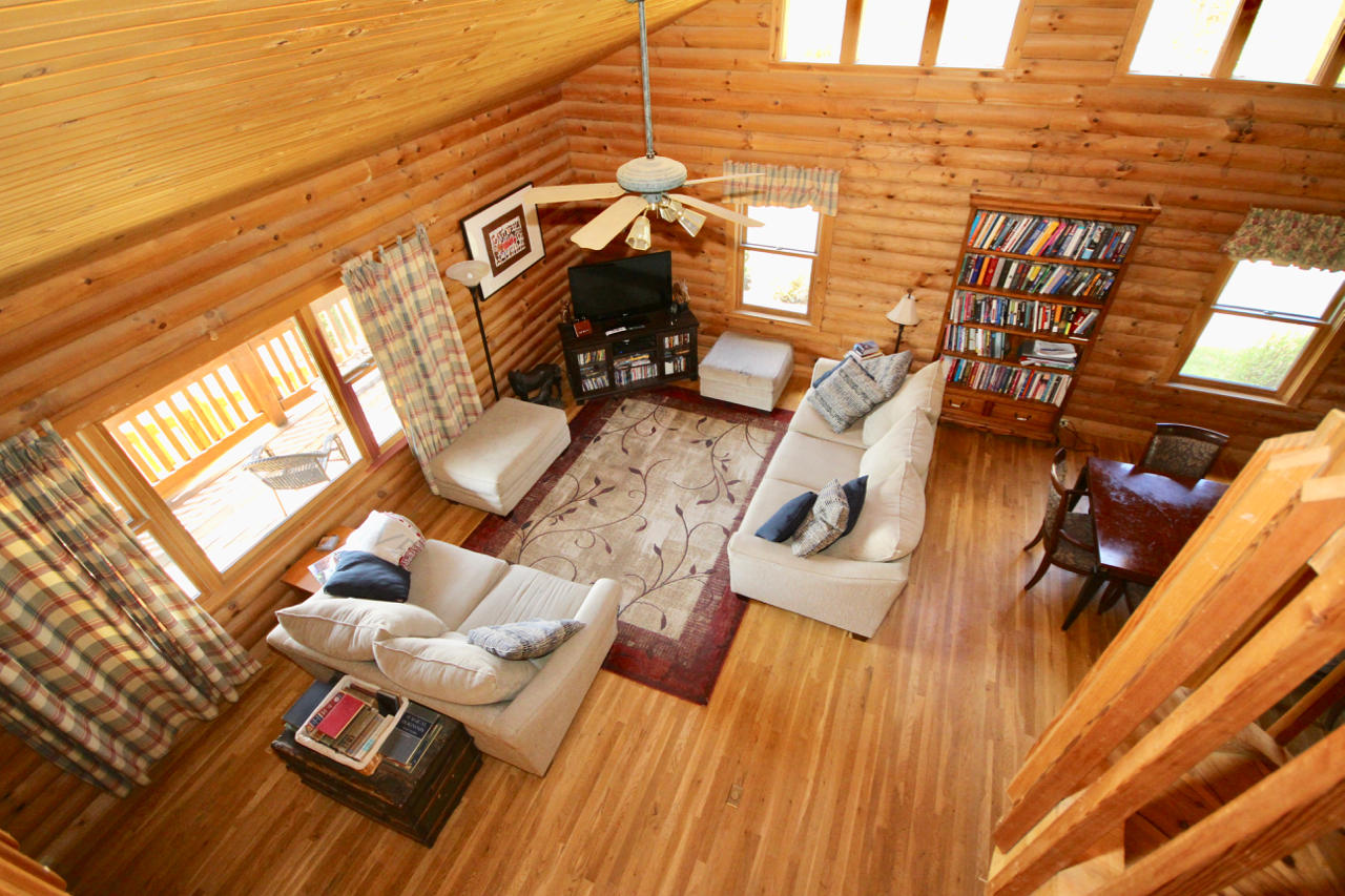 4860 Indian Valley Road Riner, VA 24149 - Photo 78 of 96 a view of a patio with table and chairs with wooden floor and fence