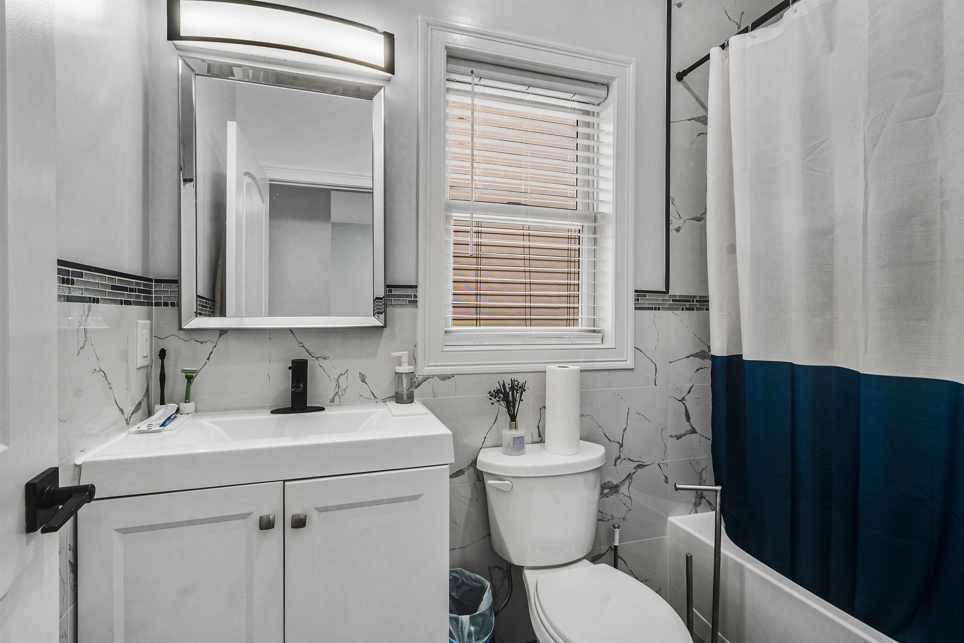 11 South 7th Street Harrison, NJ 07029 - Photo 12 of 29 a bathroom with a toilet sink and mirror