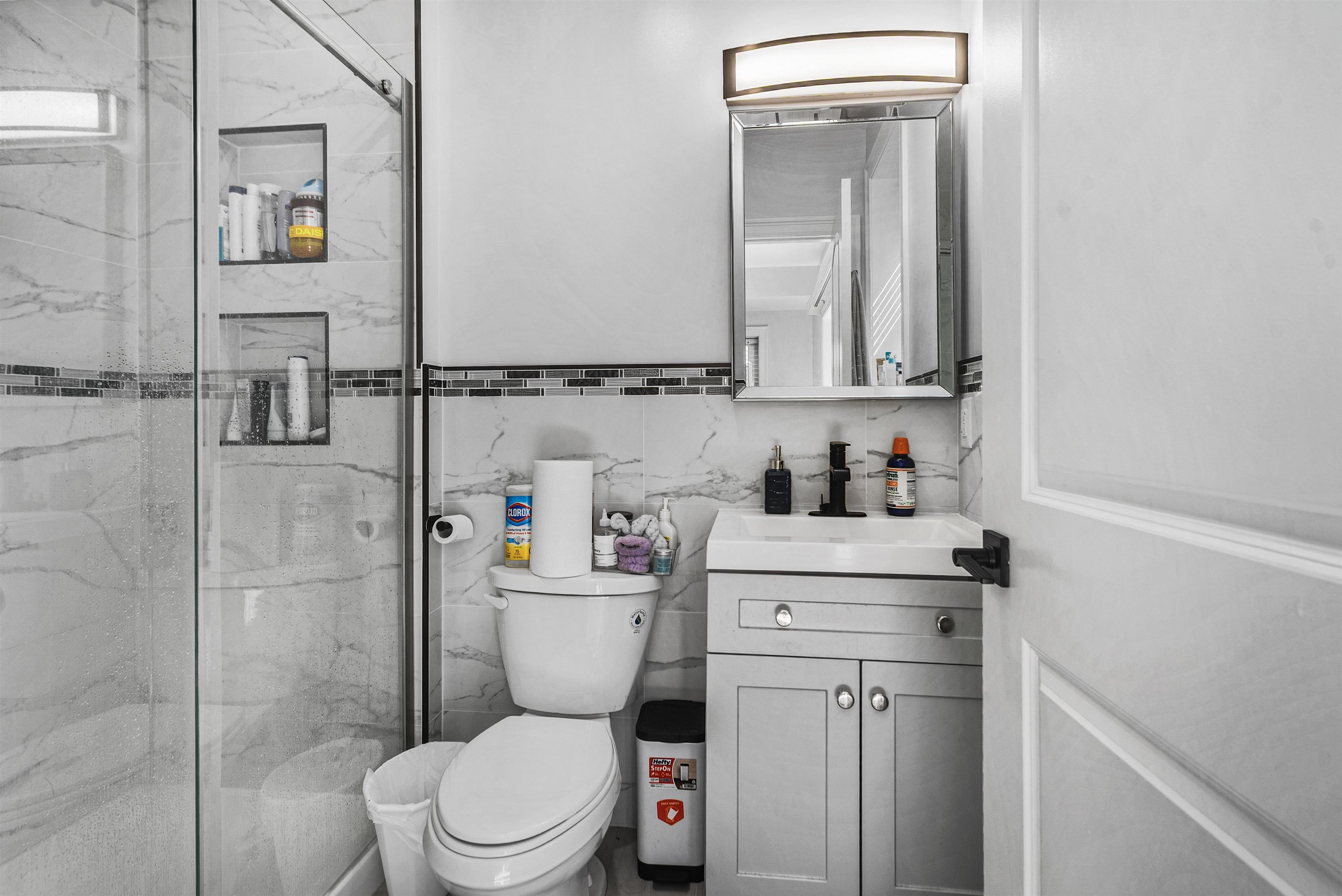 11 South 7th Street Harrison, NJ 07029 - Photo 23 of 29 a bathroom with a toilet sink vanity and mirror