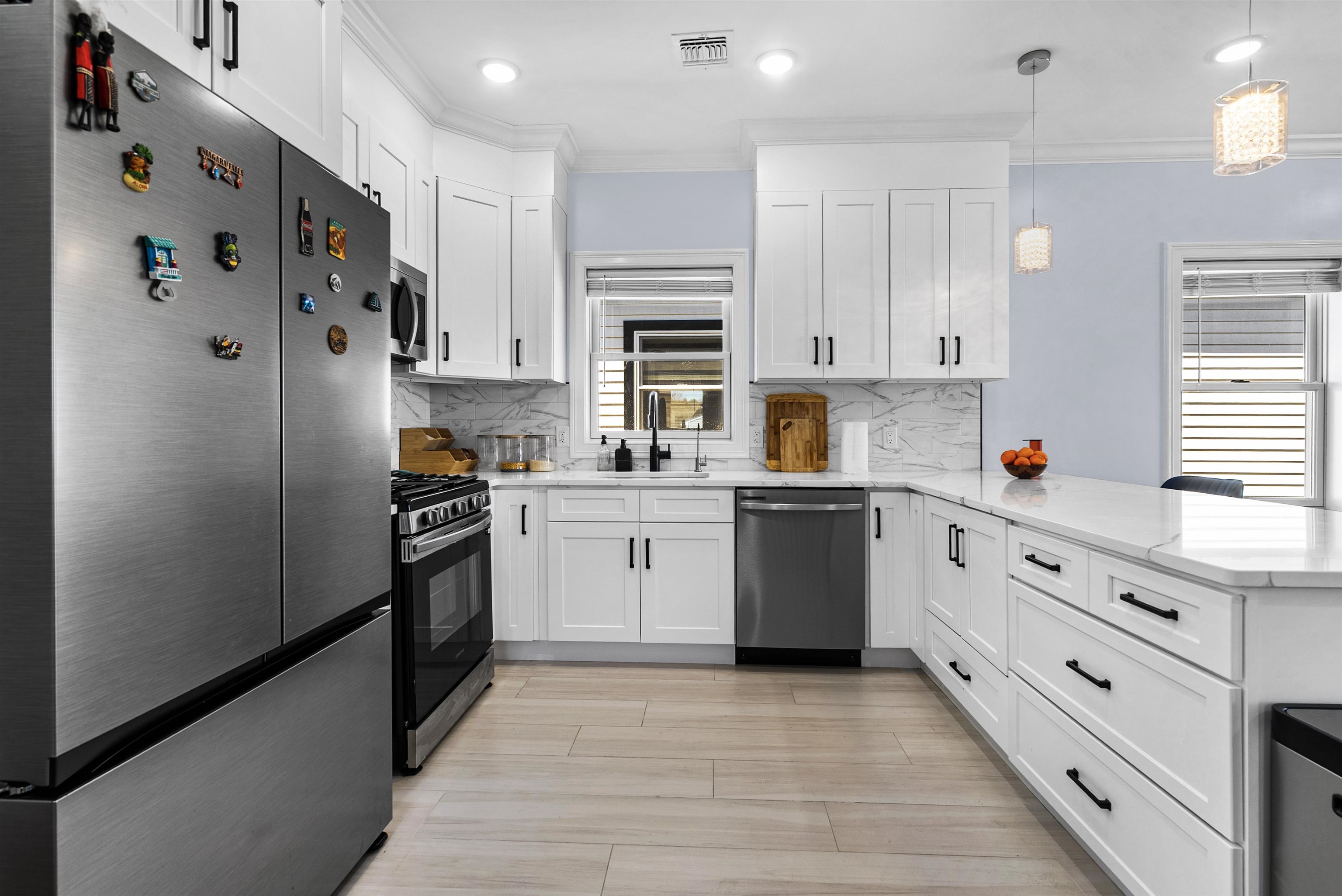 11 South 7th Street Harrison, NJ 07029 - Photo 7 of 29 a kitchen with stainless steel appliances a refrigerator sink and cabinets