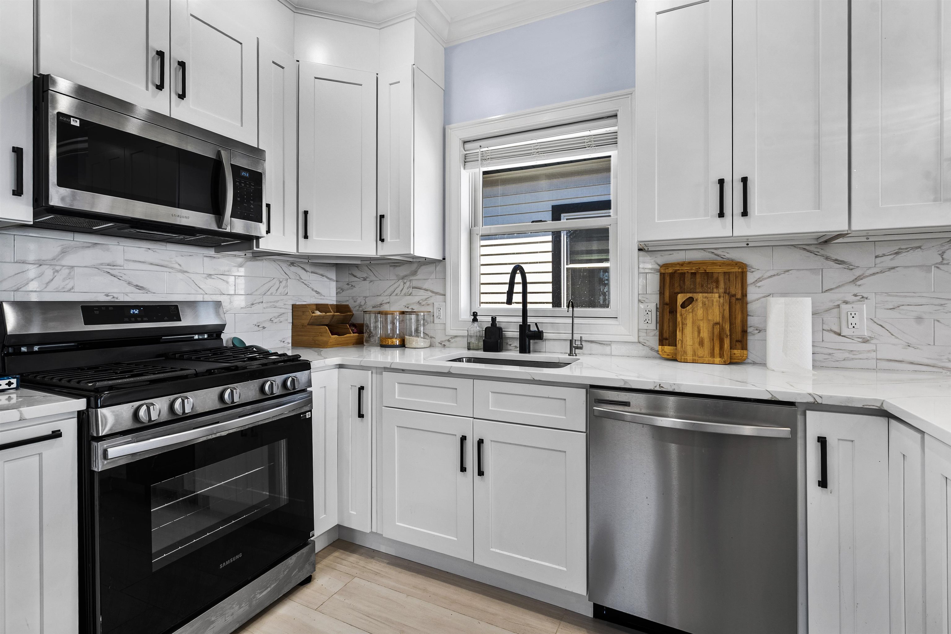 11 South 7th Street Harrison, NJ 07029 - Photo 8 of 29 a kitchen with cabinets stainless steel appliances and wooden cabinets