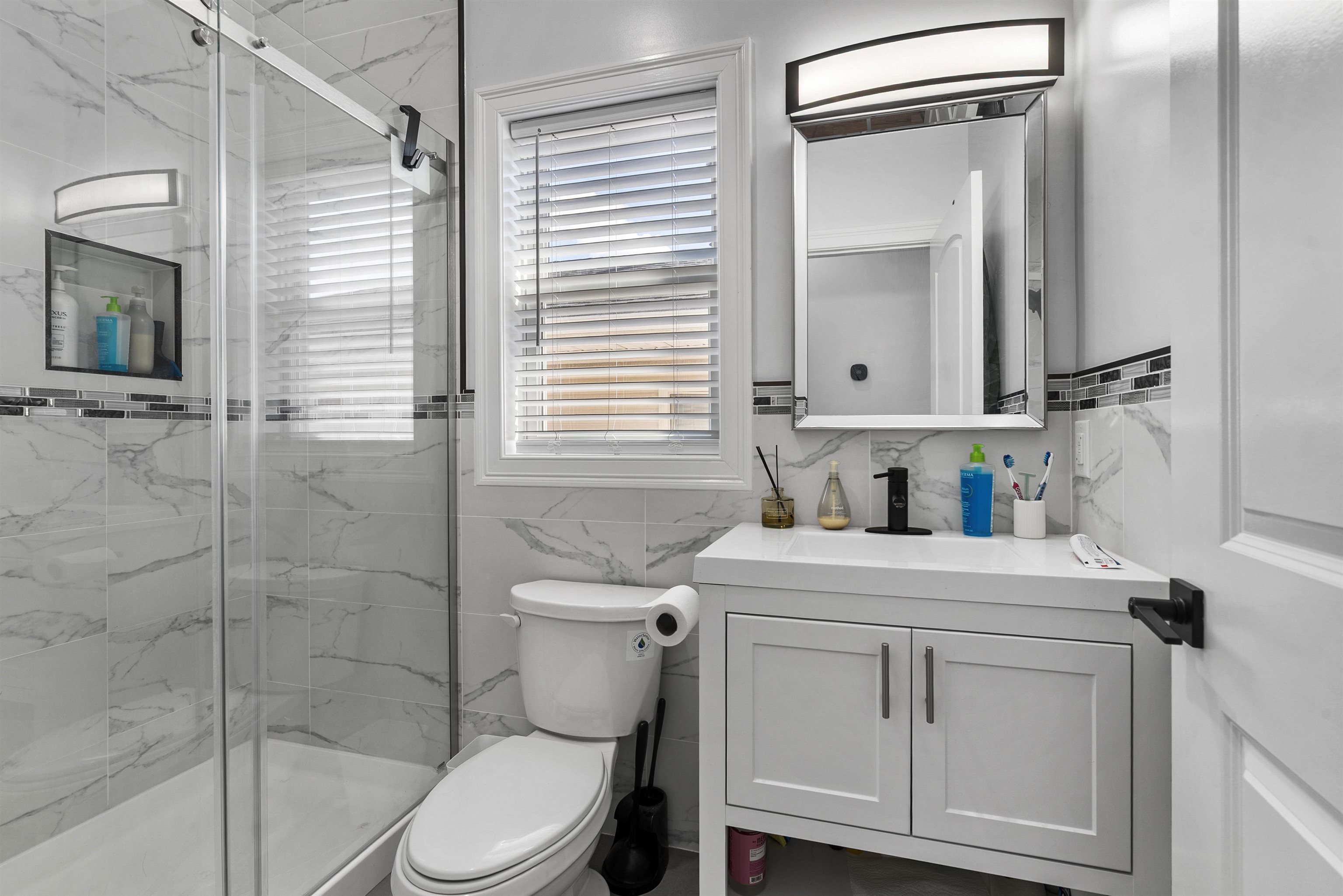 11 South 7th Street Harrison, NJ 07029 - Photo 10 of 29 a bathroom with a sink a toilet and a mirror