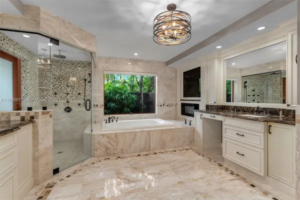 a view of a bathtub & sink in a bathroom
