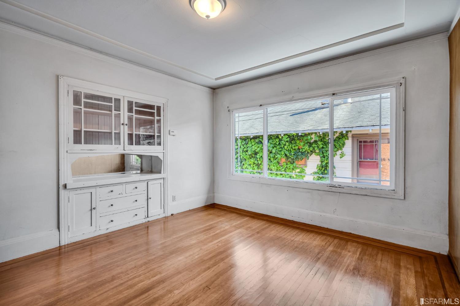 2123 Byron Street Berkeley, CA 94702 - Photo 17 of 54 wooden floor in an empty room with a window and wooden floor