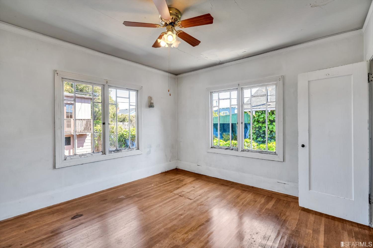 2123 Byron Street Berkeley, CA 94702 - Photo 29 of 54 a view of an empty room with wooden floor and a window