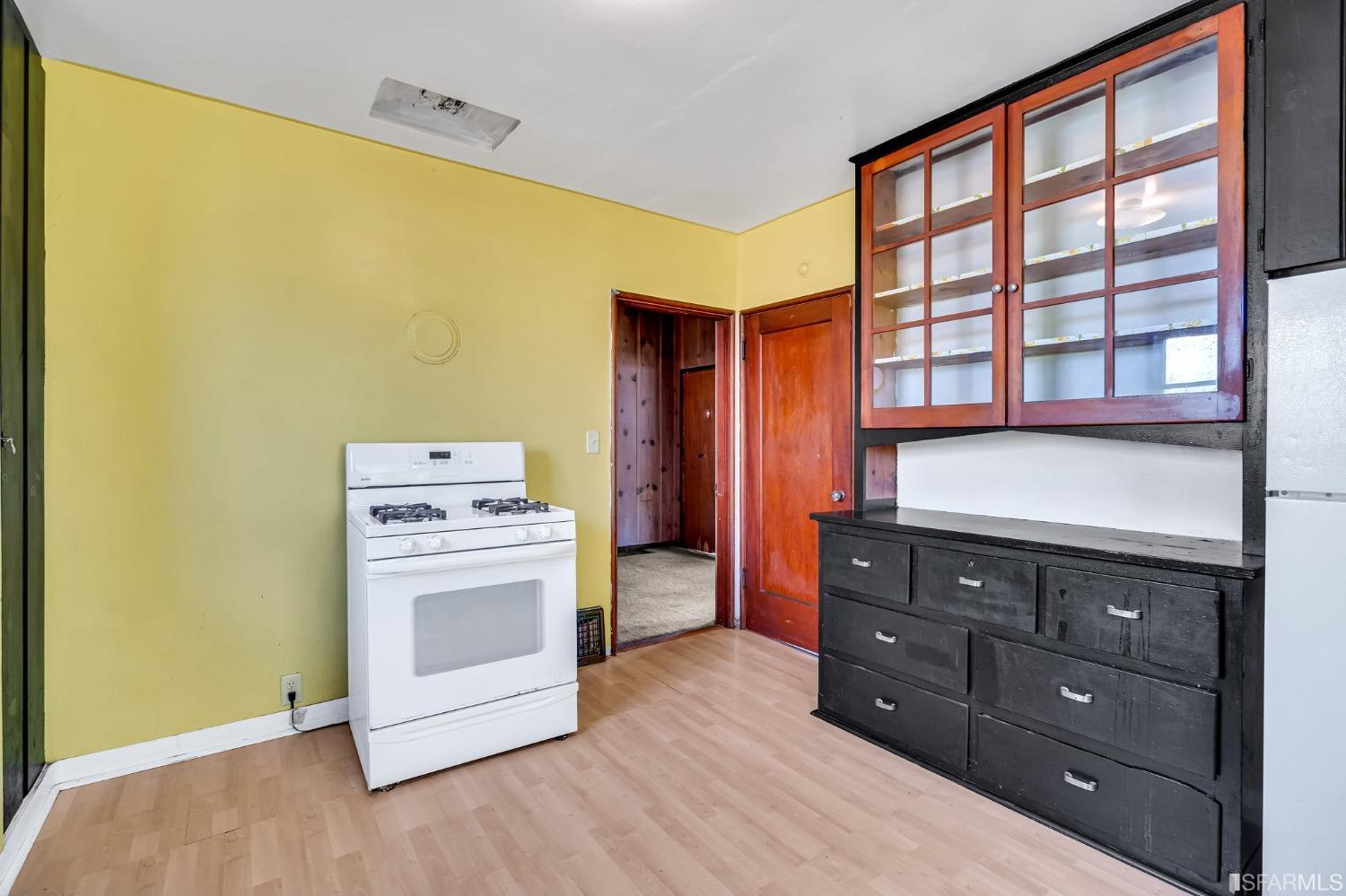 2123 Byron Street Berkeley, CA 94702 - Photo 44 of 54 a kitchen with a stove and wooden cabinets