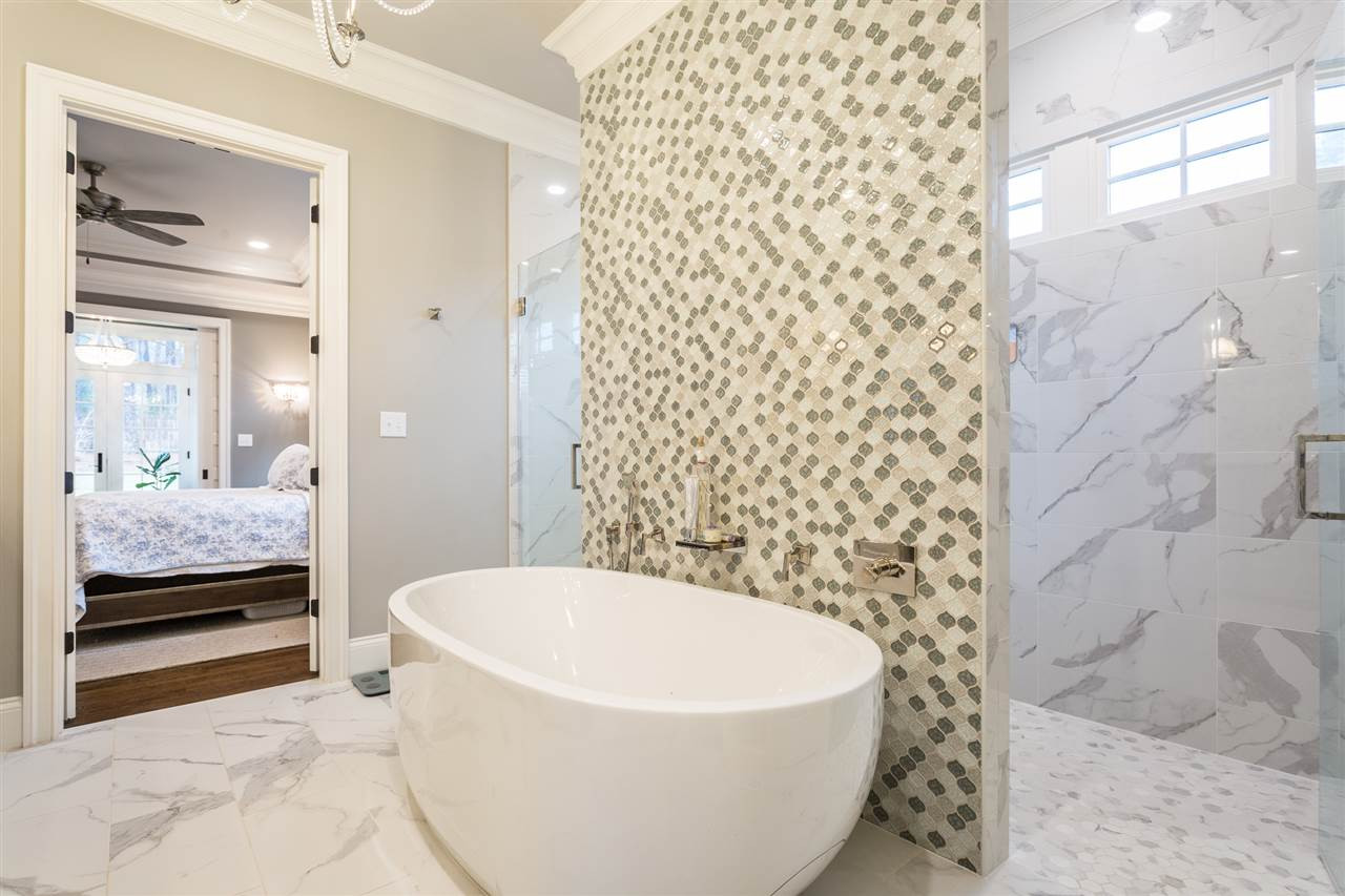 5108 Bella Ridge Drive Raleigh, NC 27615 - Photo 18 of 29 A lovely ceramic tile backdrop cascades behind the tub. Jetted Soaking Tub
