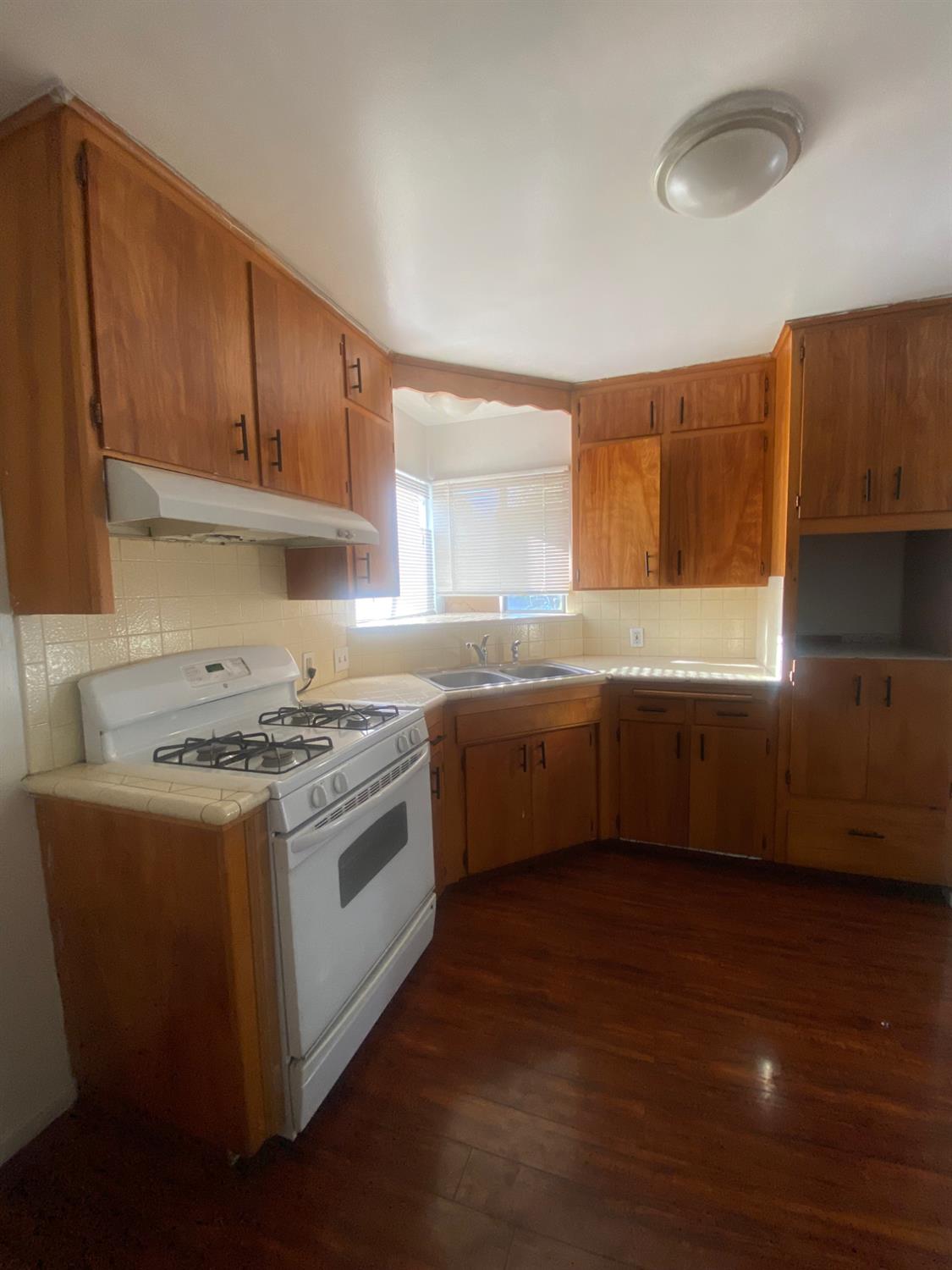333 East Linden Avenue Reedley, CA 93654 - Photo 10 of 21 a kitchen with a sink a stove and cabinets