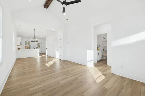 a view of empty room with wooden floor