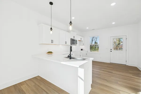 a view of a kitchen with wooden floor