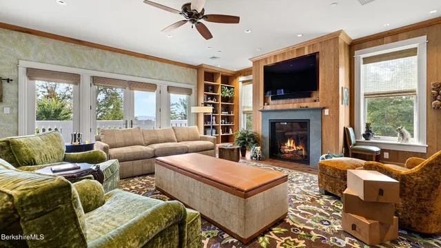 a living room with furniture a flat screen tv and a fireplace