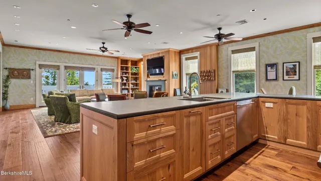 a view of a kitchen counter space wooden floor and windows