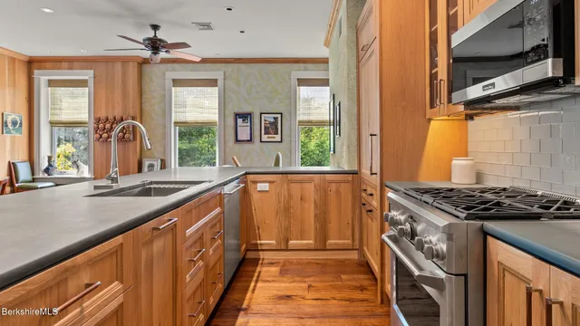 a kitchen with sink a stove and a window
