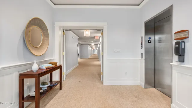 a view of a hallway with entryway wooden floor and front door