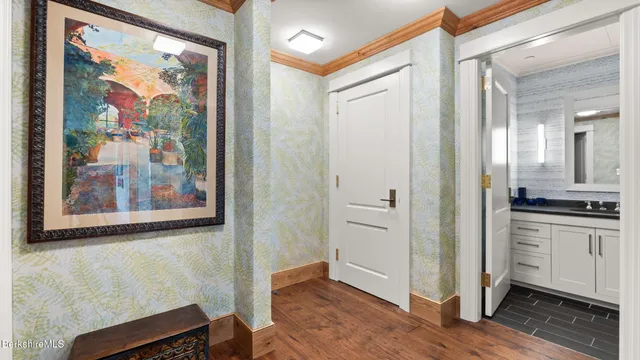 a view of a hallway with wooden floor and workspace