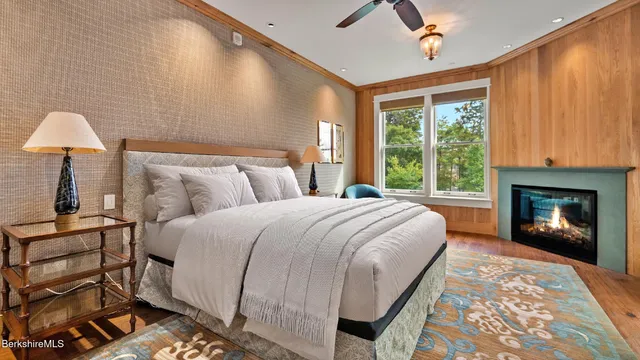 a spacious bedroom with a bed and a fireplace