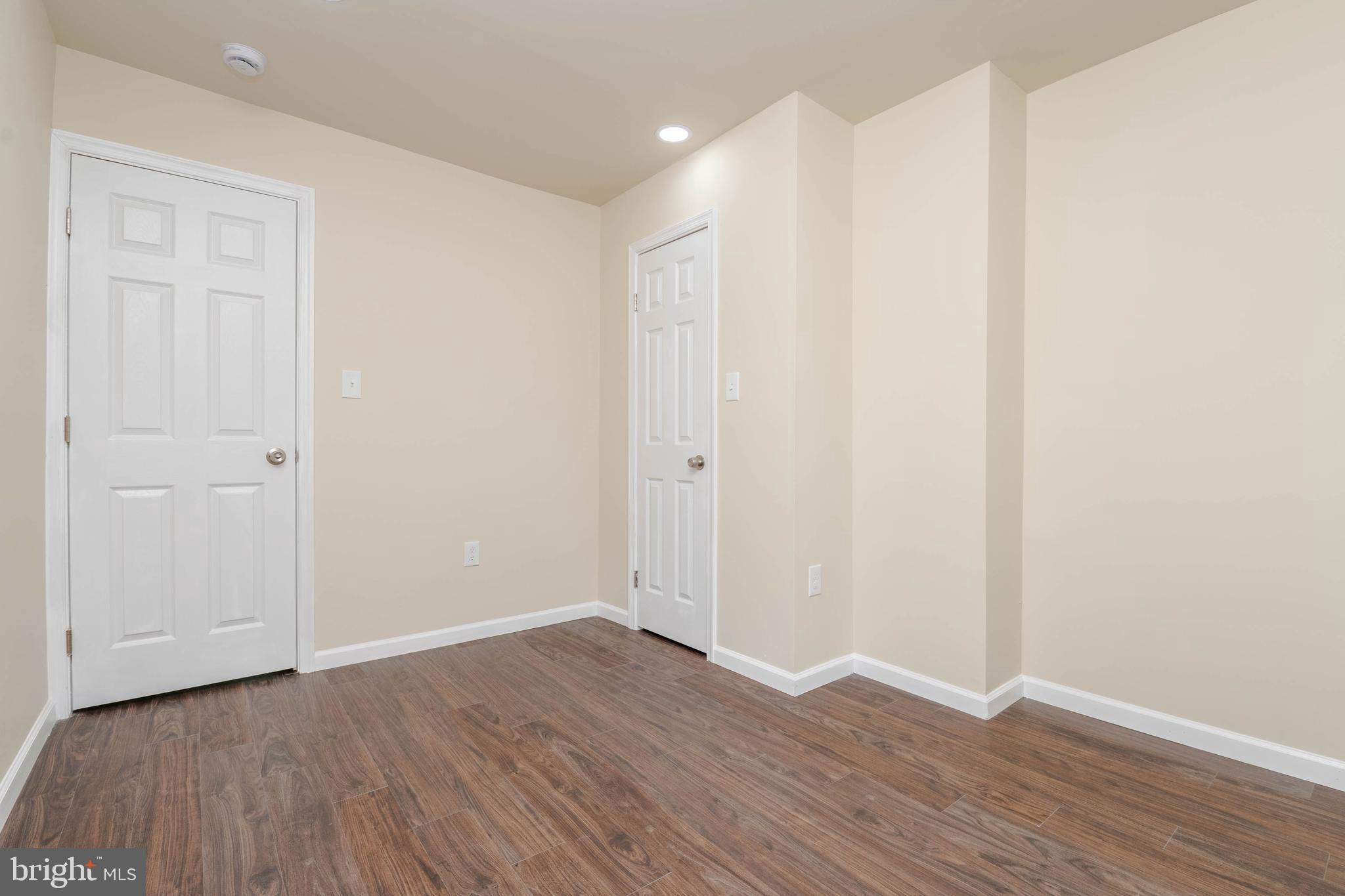 1839 Ramsay Street Baltimore, MD 21223 - Photo 12 of 22 a view of an empty room with wooden floor