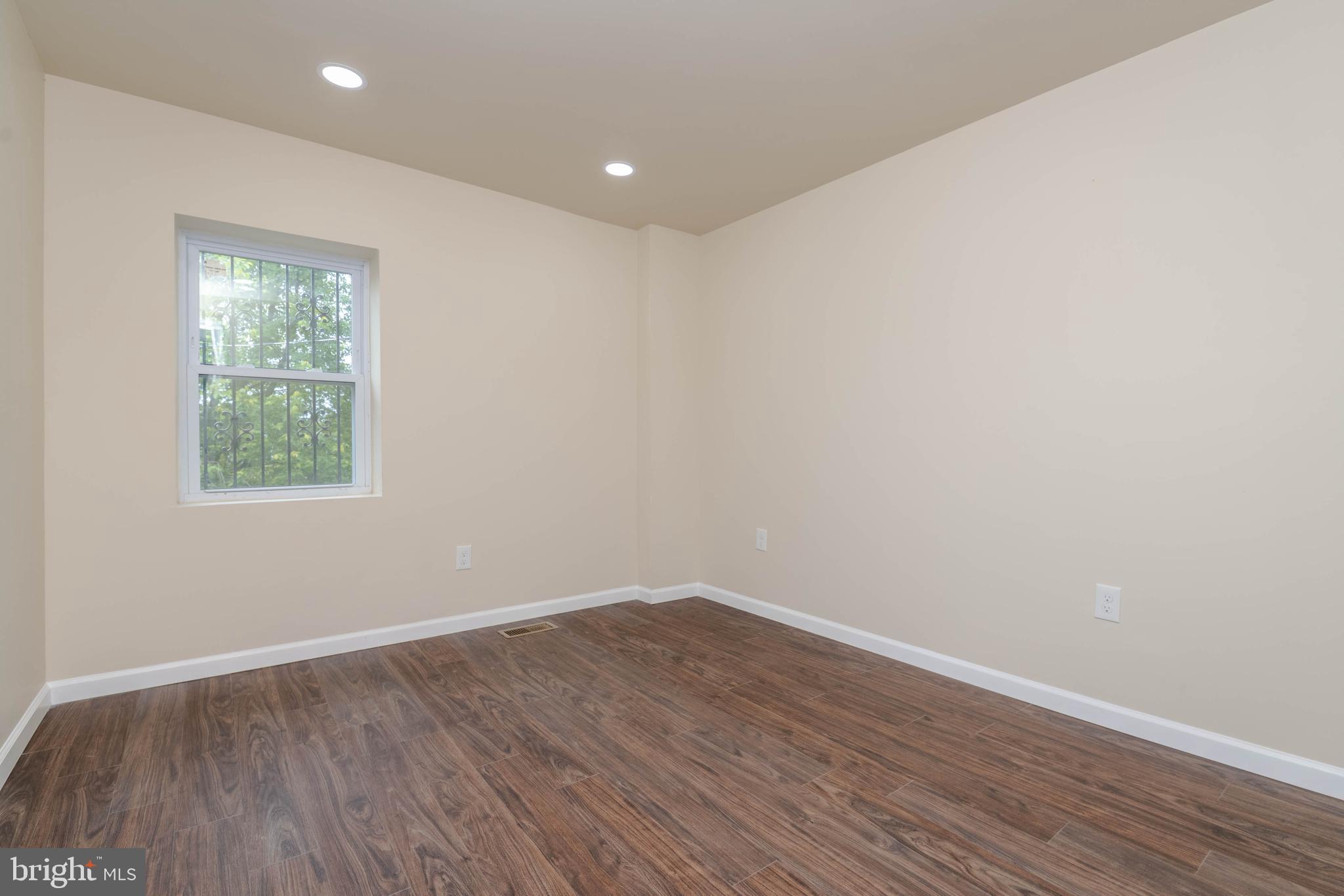 1839 Ramsay Street Baltimore, MD 21223 - Photo 14 of 22 an empty room with wooden floor and windows
