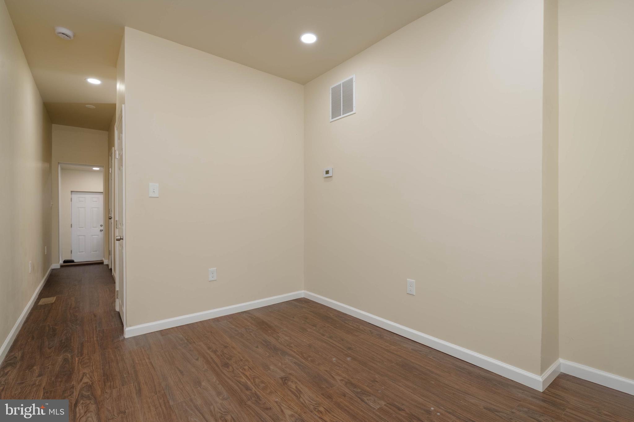 1839 Ramsay Street Baltimore, MD 21223 - Photo 2 of 22 a view of an empty room with wooden floor and closet