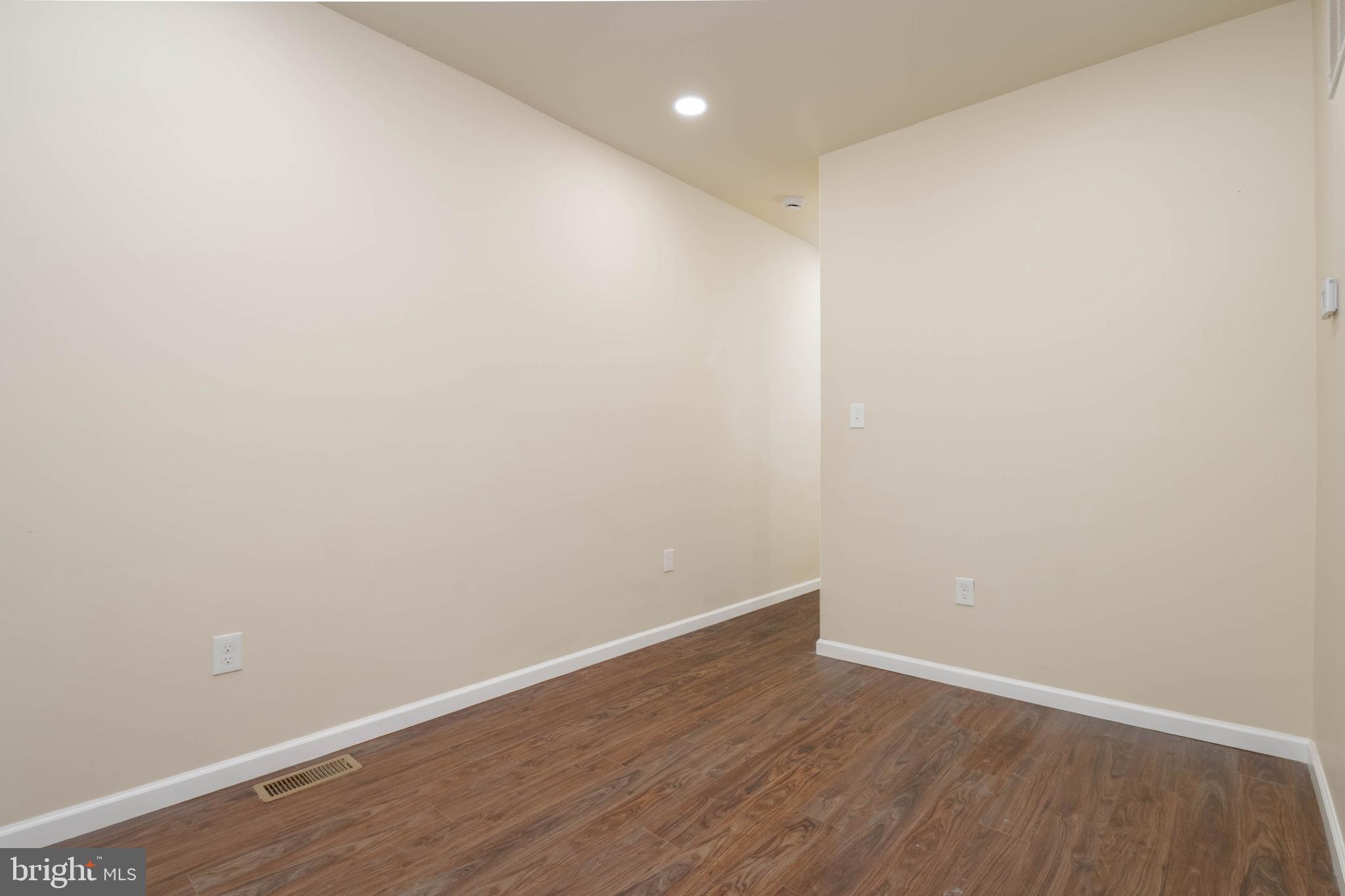 1839 Ramsay Street Baltimore, MD 21223 - Photo 5 of 22 a view of an empty room with wooden floor