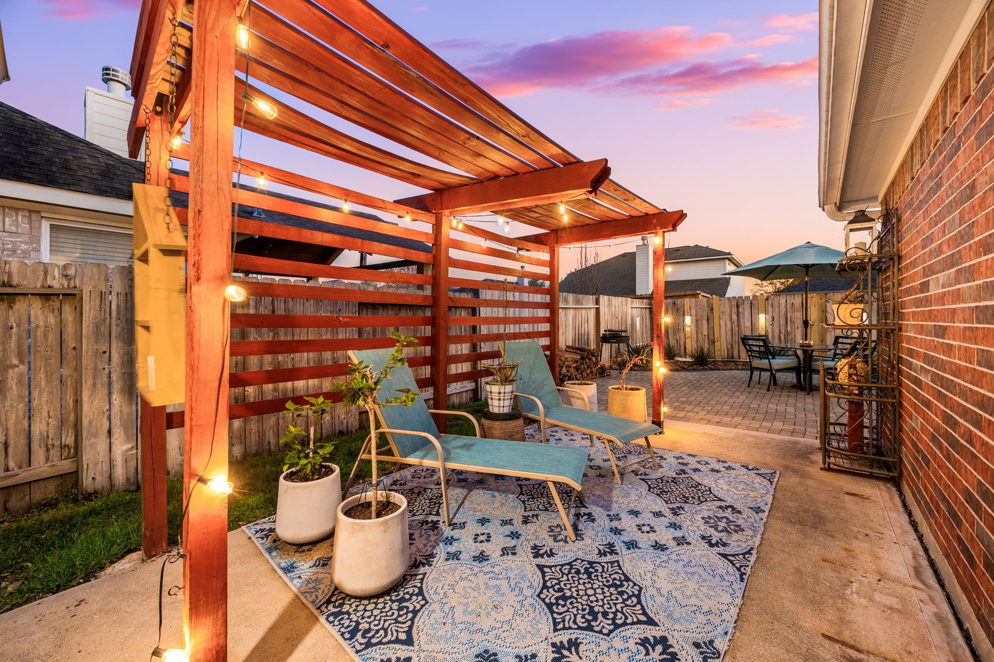 20707 Sapphire Lake Road Richmond, TX 77407 - Photo 6 of 13 At the end of your long day, head outside and enjoy the pergola, lights and peaceful setting created out back.