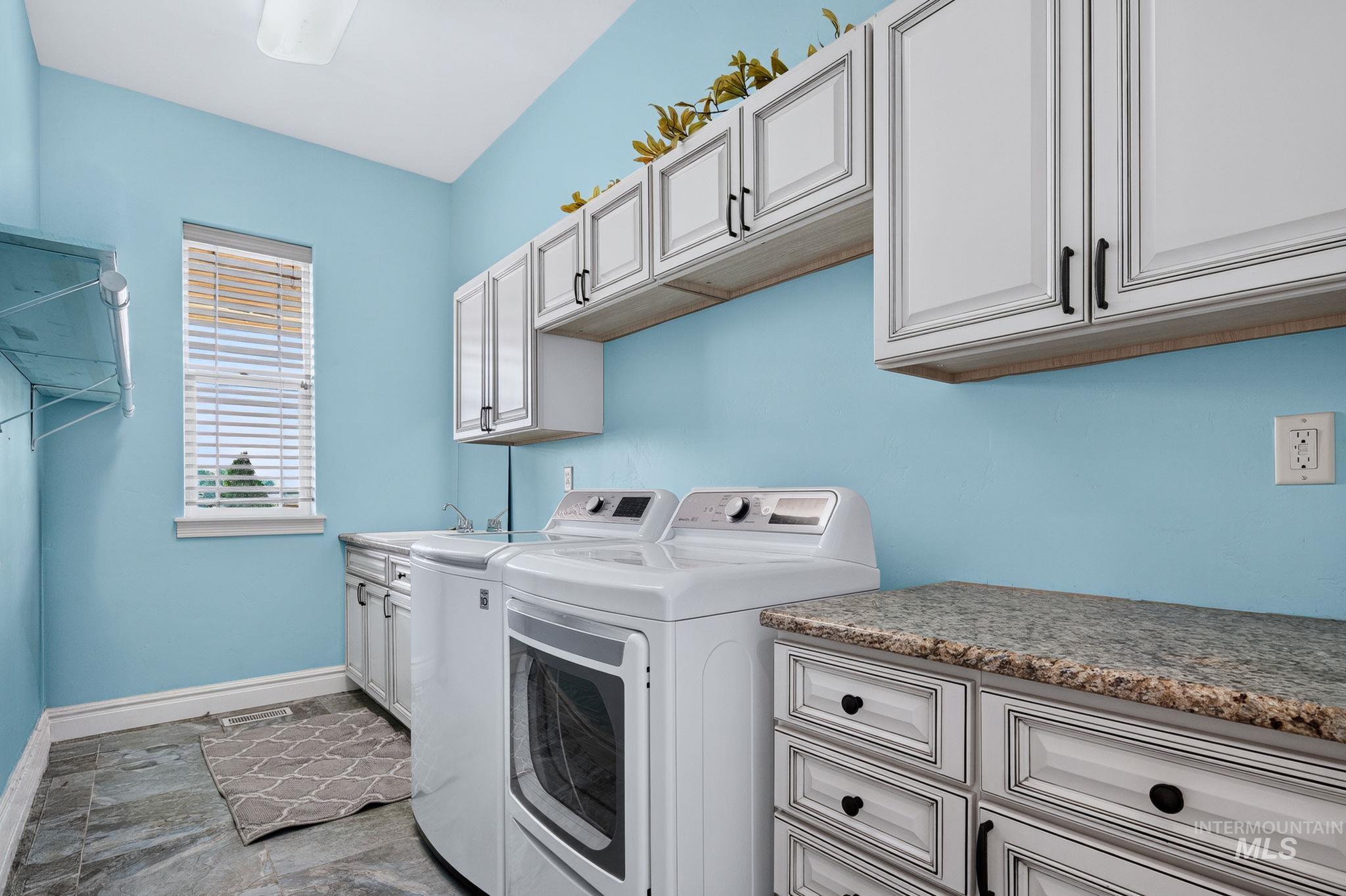 11378 Purple Sage Road Middleton, ID 83644 - Photo 29 of 50 Bathroom featuring dual vanities with granite countertops, mosaic tile backsplash, and light wood cabinetry