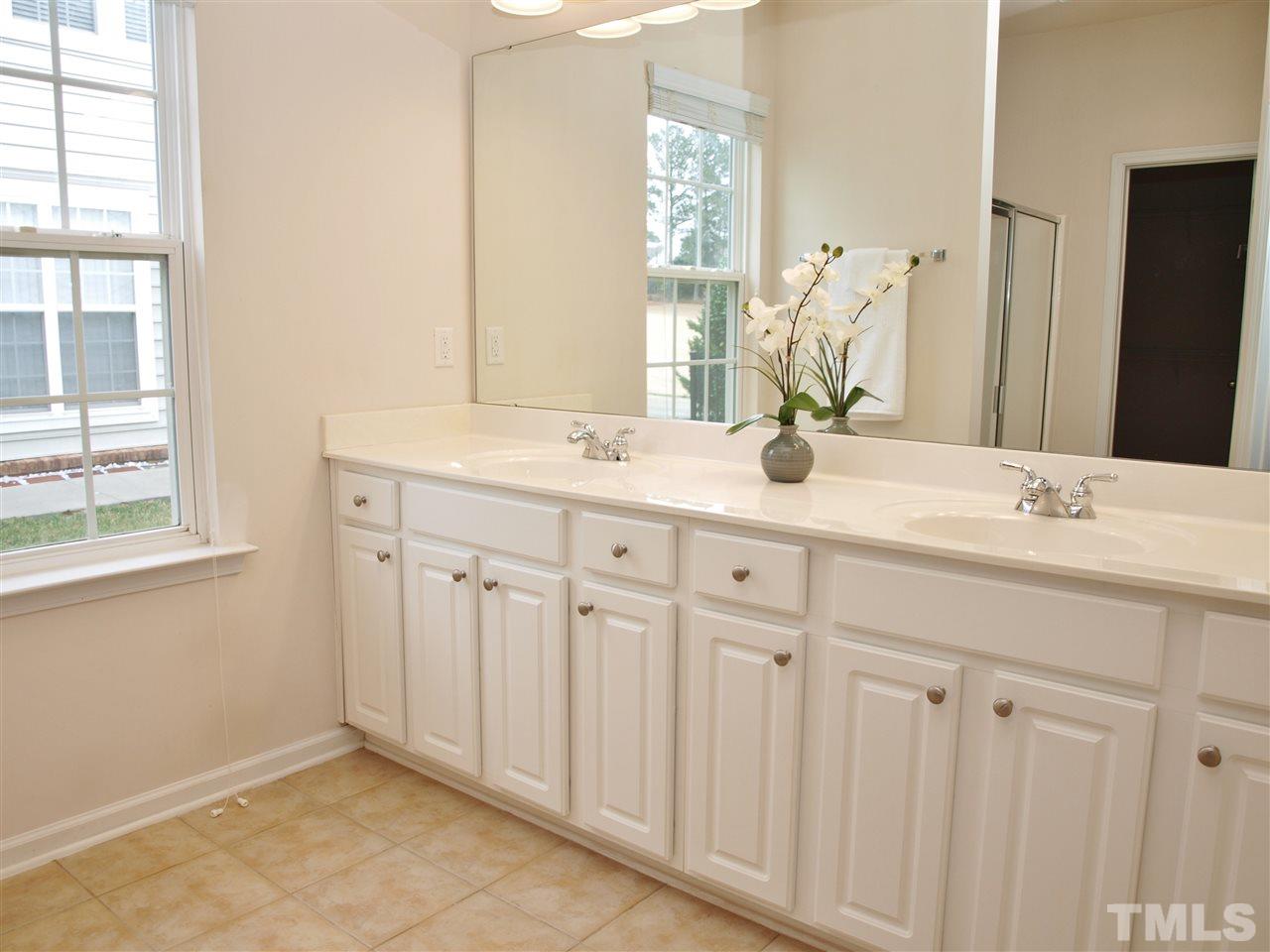 3609 Cathedral Bell Road Raleigh, NC 27614 - Photo 11 of 23 a bathroom with a double vanity sink and a mirror
