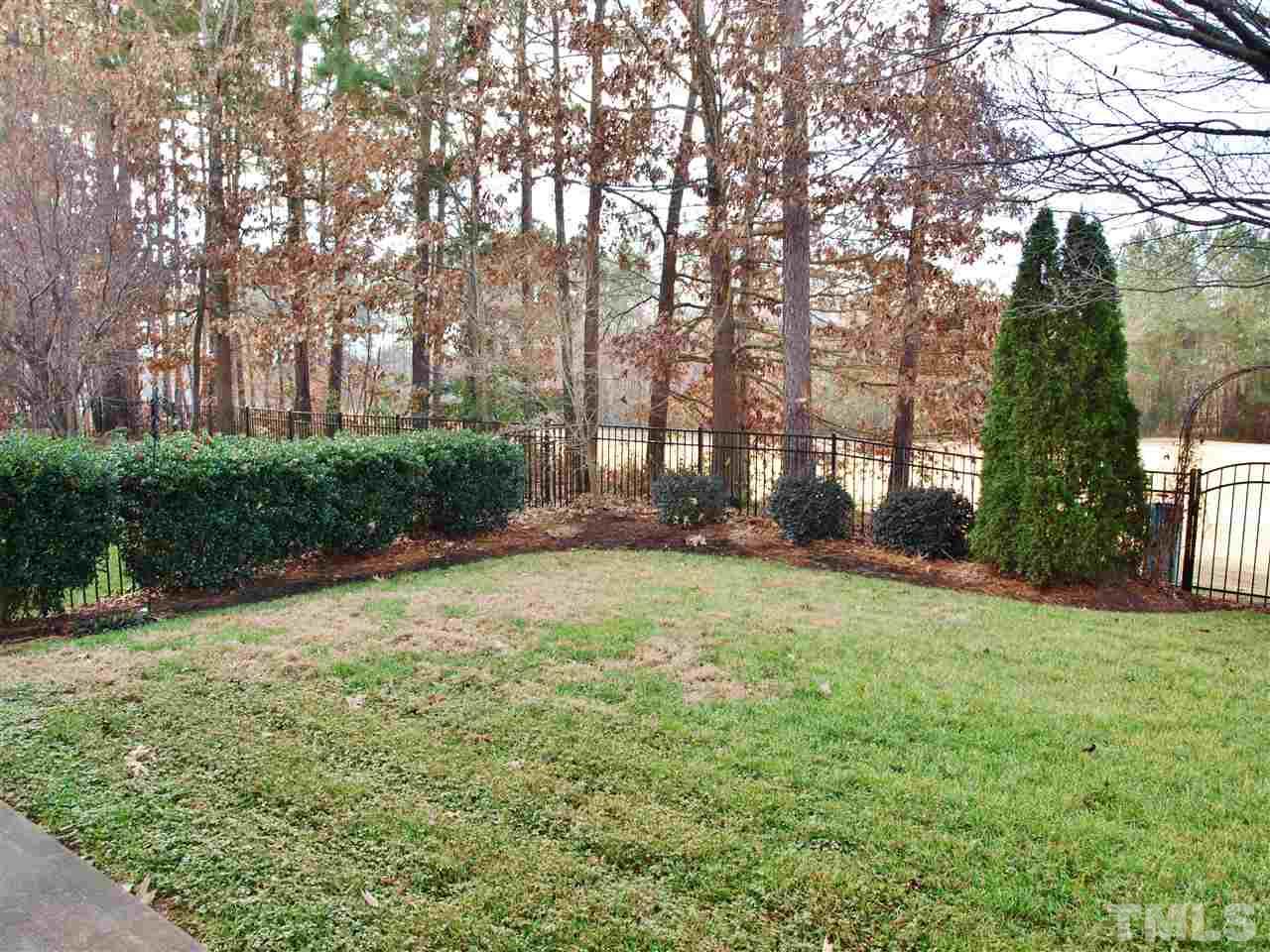 3609 Cathedral Bell Road Raleigh, NC 27614 - Photo 22 of 23 a backyard of a house with lots of green space and fountain