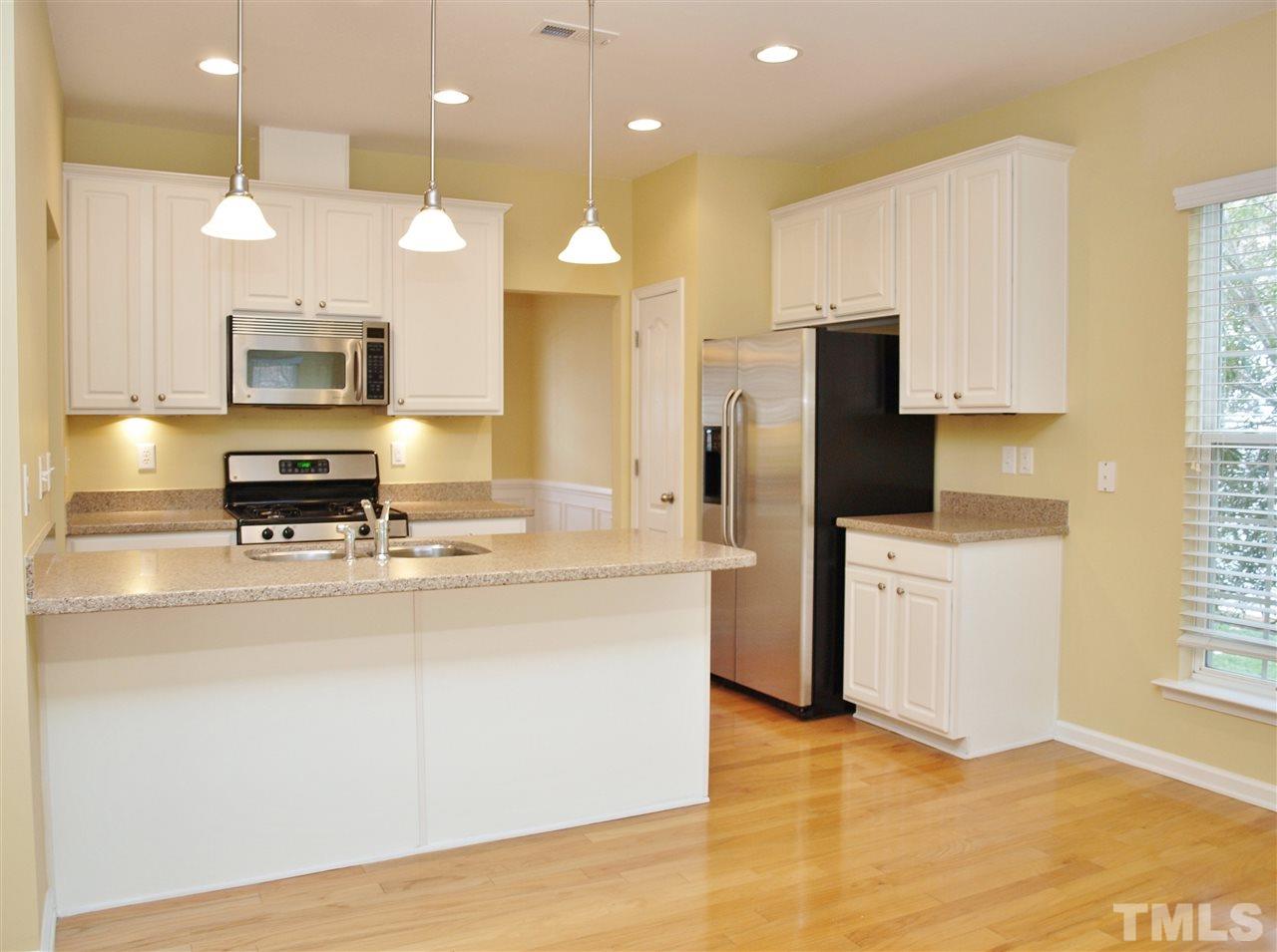 3609 Cathedral Bell Road Raleigh, NC 27614 - Photo 7 of 23 a kitchen with stainless steel appliances granite countertop a stove a sink and a refrigerator