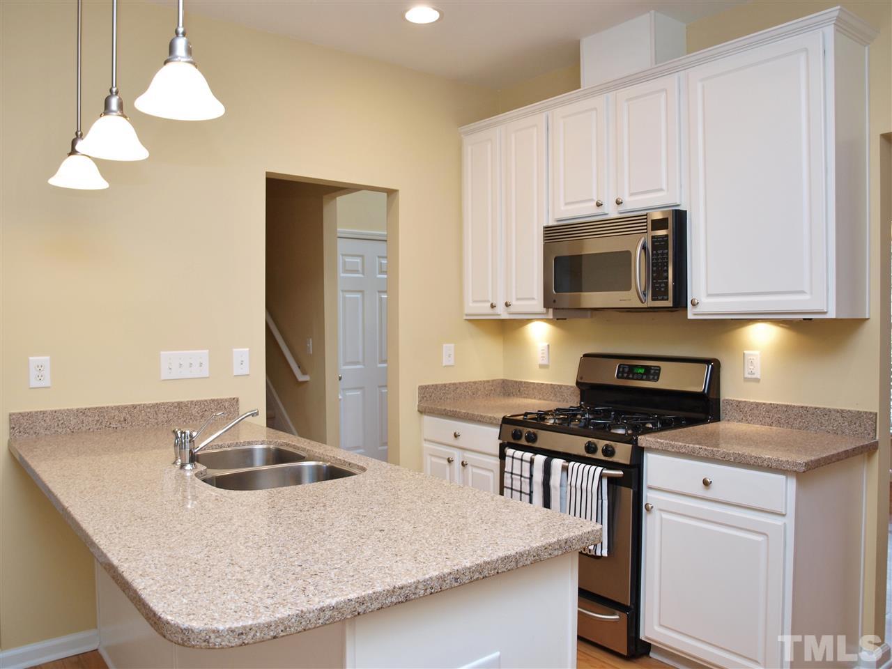 3609 Cathedral Bell Road Raleigh, NC 27614 - Photo 8 of 23 a kitchen with granite countertop a sink a stove and cabinets