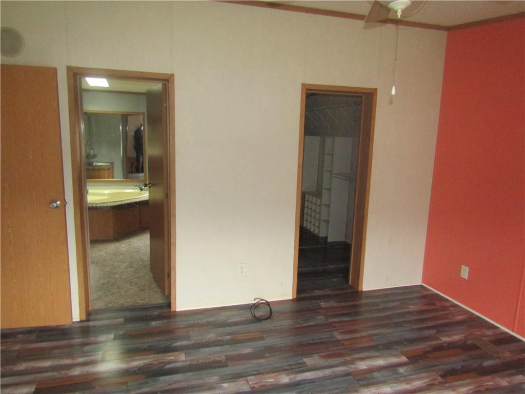 521 Williams Street Confluence, PA 15424 - Photo 16 of 38 a view of a hallway with wooden floor and a bathroom