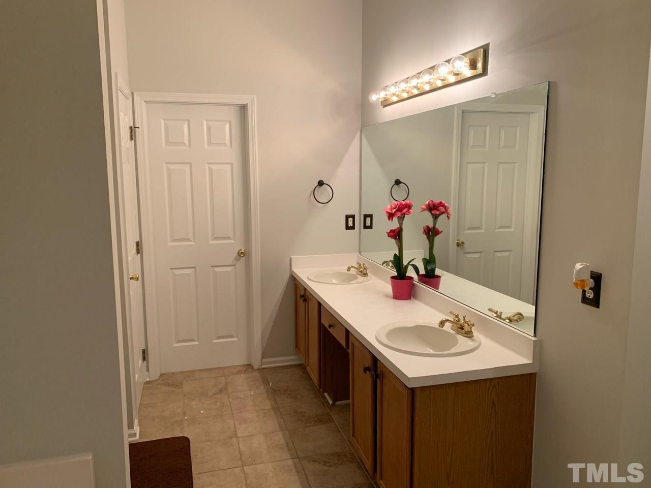 4516 Drewbridge Way Raleigh, NC 27604 - Photo 14 of 23 a bathroom with a sink and a mirror